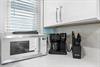 The  kitchen comes equipped with everything you need  microwave, premium coffee maker, and quality knives.