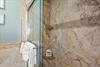 Step into the walkin shower with luxurious marble walls and fresh towels waiting for you.