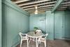 Covered patio with table and chairs for card games or cocktails and an outdoor shower to rinse the days sand away