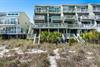 Beachfront rental homes with direct access to pristine sandy shores and native dune vegetation.