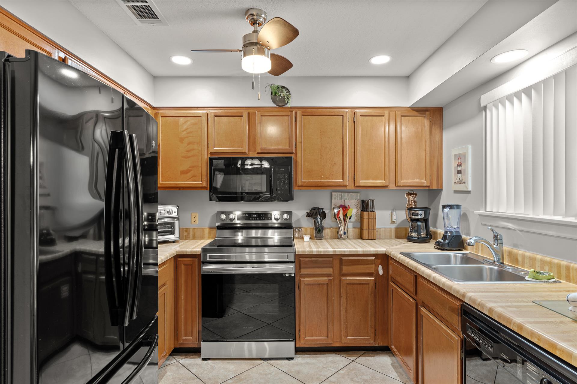The fully equipped kitchen features stainless steel appliances