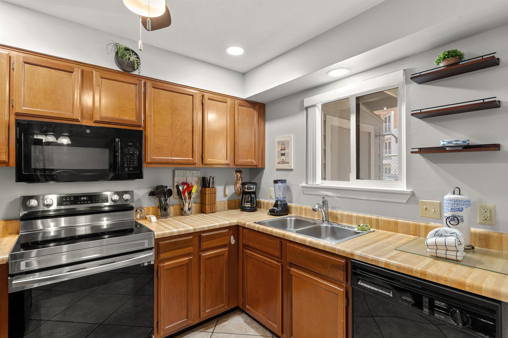 Kitchen with warm wood cabinetry and everything needed to create memorable meals during your stay.