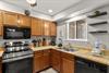 Kitchen with warm wood cabinetry and everything needed to create memorable meals during your stay.