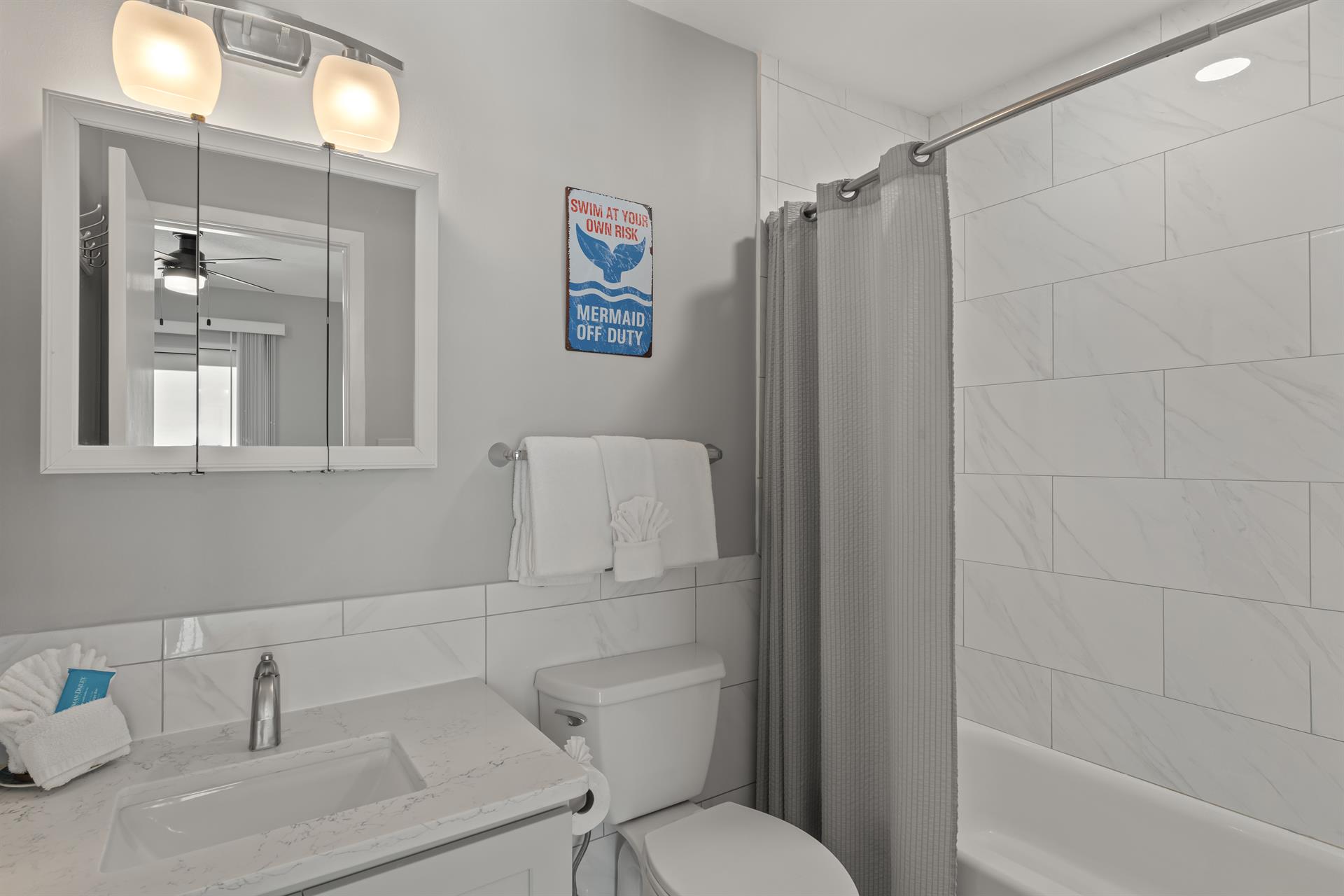 Bathroom 2 has a tub, perfect for soaking after a day at the beach