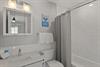 Bathroom 2 has a tub, perfect for soaking after a day at the beach