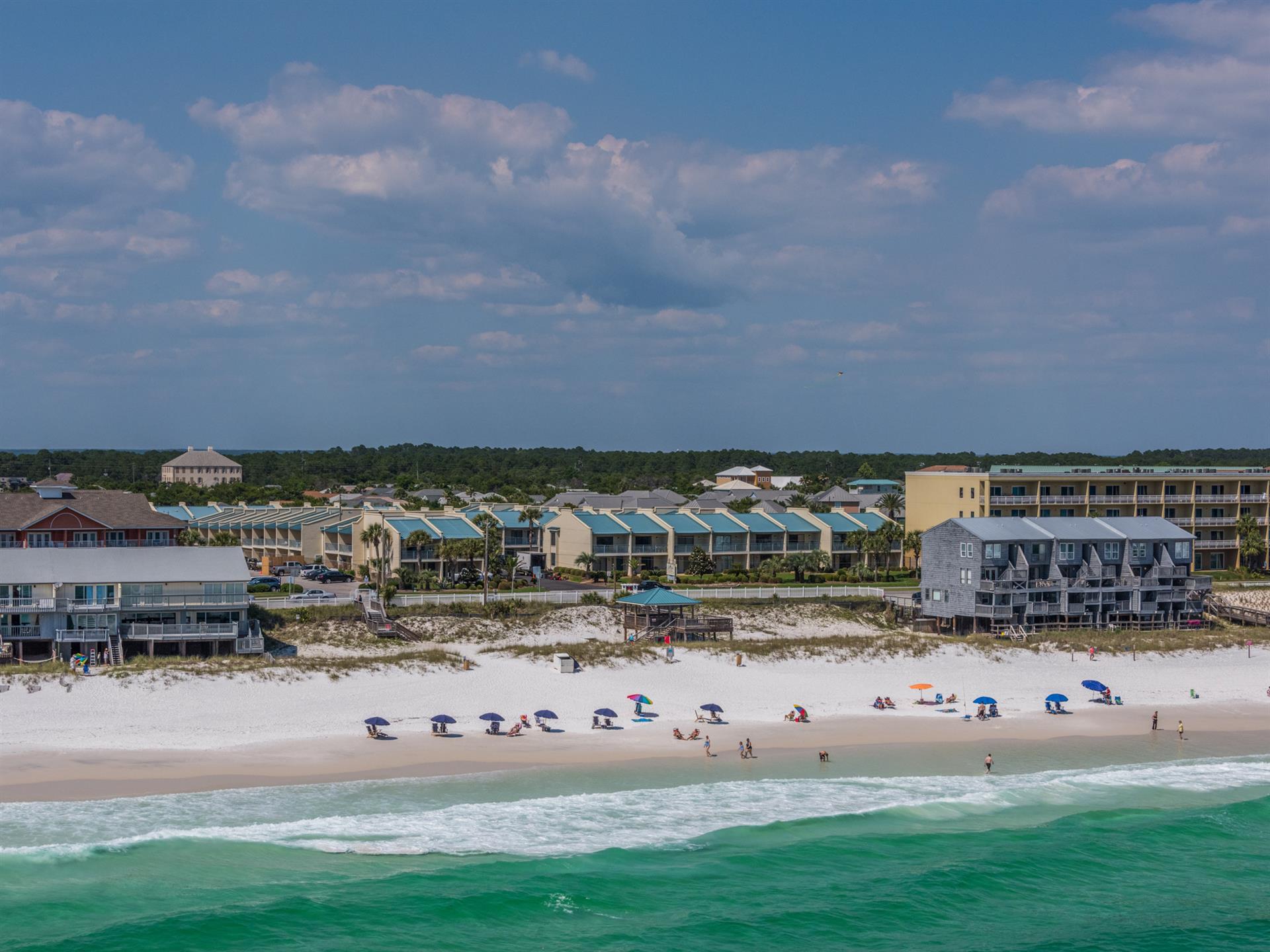 Pristine white sand beach meets emerald Gulf waters in this stunning coastal community setting.