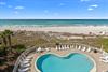 Coastal property featuring pool access and beachfront location with pristine white sand and turquoise waters stretching to the horizon.