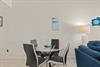 Gather around this sleek glass dining table, where modern style meets coastal charm. The soft lighting and oceaninspired décor create a welcoming atmosphere for your meals together.
