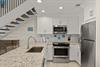 Your bright, modern kitchen features granite countertops, stainless steel appliances, and charming coastal decor—perfect for preparing meals or brewing morning coffee in your home away from home.