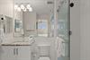 1st Floor Bathroom 1  Shared Bath  Step into your bathroom with pristine white subway tiles, a walkin glass shower, and a granite vanity. Fresh towels, and a wallmounted hairdryer.