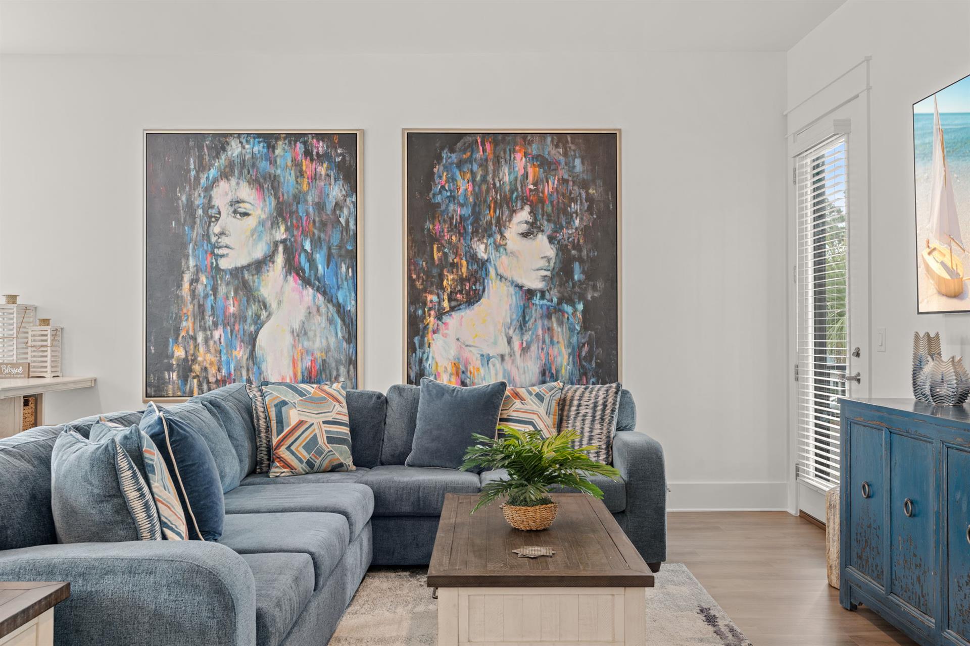 Sink into plush sectional seating beneath striking artwork, where your vacation moments unfold in this thoughtfully designed living space with tasteful coastalinspired touches.