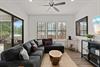 Sink into plush charcoal seating as the ceiling fan cools you. Natural light pours through sliding doors to your private patio with builtin grill—perfect for lazy mornings and evening gatherings.