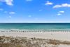 Pristine white sand beach with turquoise waters stretches along the propertys location, offering a stunning Gulf Coast setting for a relaxing coastal getaway.