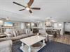 Unwind in this spacious, openconcept living area where coastal elegance meets comfort.