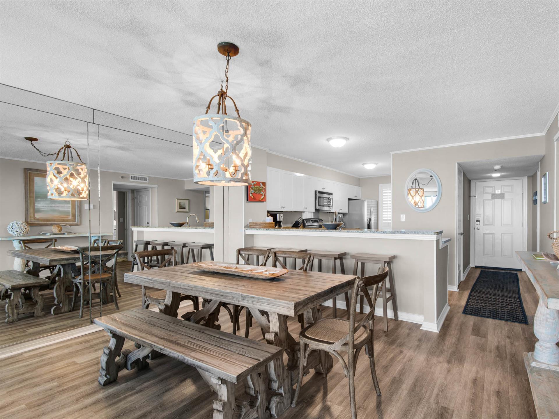 Gather everyone around this spacious dining and kitchen area, where rustic farmhouse charm meets modern convenience for memorable meals together.