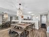 Gather everyone around this spacious dining and kitchen area, where rustic farmhouse charm meets modern convenience for memorable meals together.