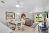 Gather around the welcoming dining table for meals together, then unwind on comfy sofas while enjoying garden views through sliding glass doors.