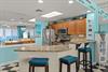 The kitchen invites culinary adventures with modern appliances and turquoiseteal decor that captures the coastal vibe