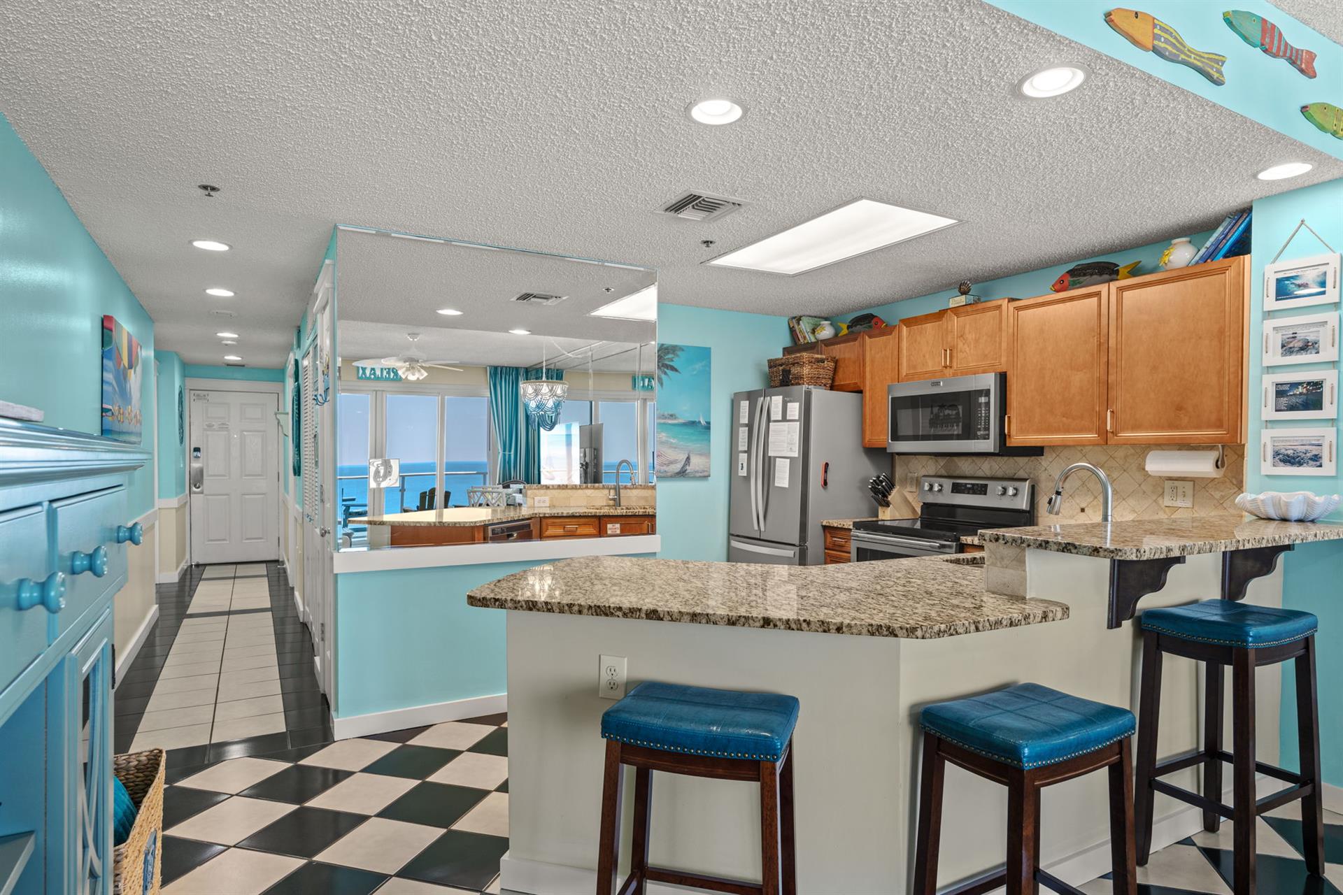 Fullyequipped kitchen featuring granite counters and stunning ocean views beyond.