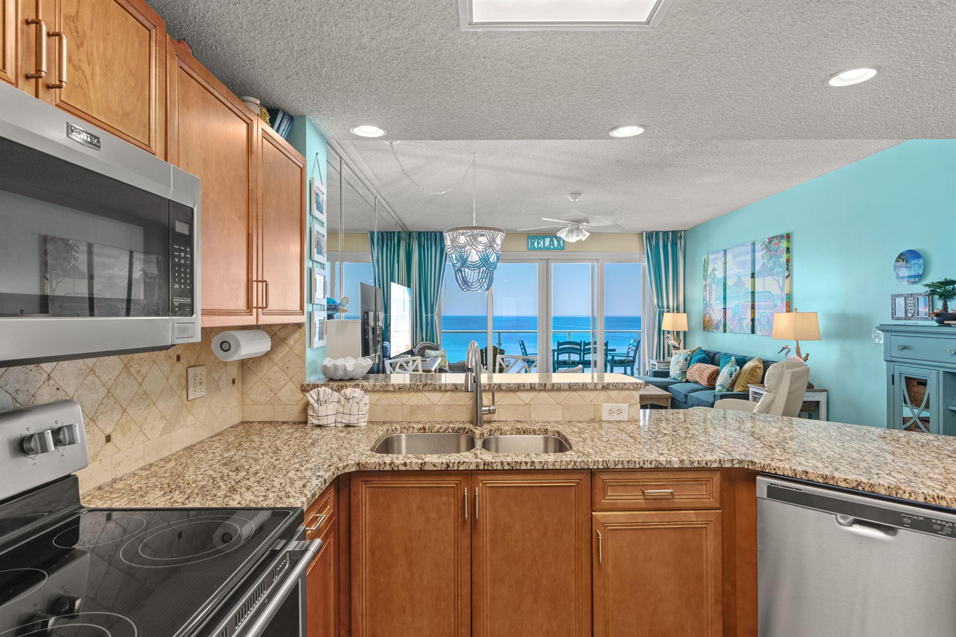 The spacious design flows seamlessly into the living area, where turquoise waters create a serene backdrop