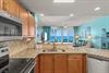 The spacious design flows seamlessly into the living area, where turquoise waters create a serene backdrop