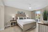 Crisp linens and coastal charm in the serene primary bedroom retreat plus a private balcony.