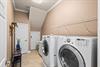 A dedicated laundry space awaits, complete with a fullsize washer and dryer—