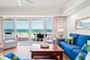 Unwind on plush sofas as your balcony frames stunning turquoise waves and soft sands just steps away.