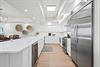 Gather, cook, and create memories in this bright, fullyequipped kitchen featuring stainless steel appliances, quartz countertops.