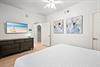 Unwind in the bright, airy bedroom with a plush bed, stylish coastal décor, and a flatscreen TV.
