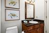 This bathroom features a granitetopped vanity, elegant fixtures, and charming sea turtle artwork.