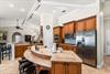 The kitchen features granite counters, stainless appliances, and an open layout