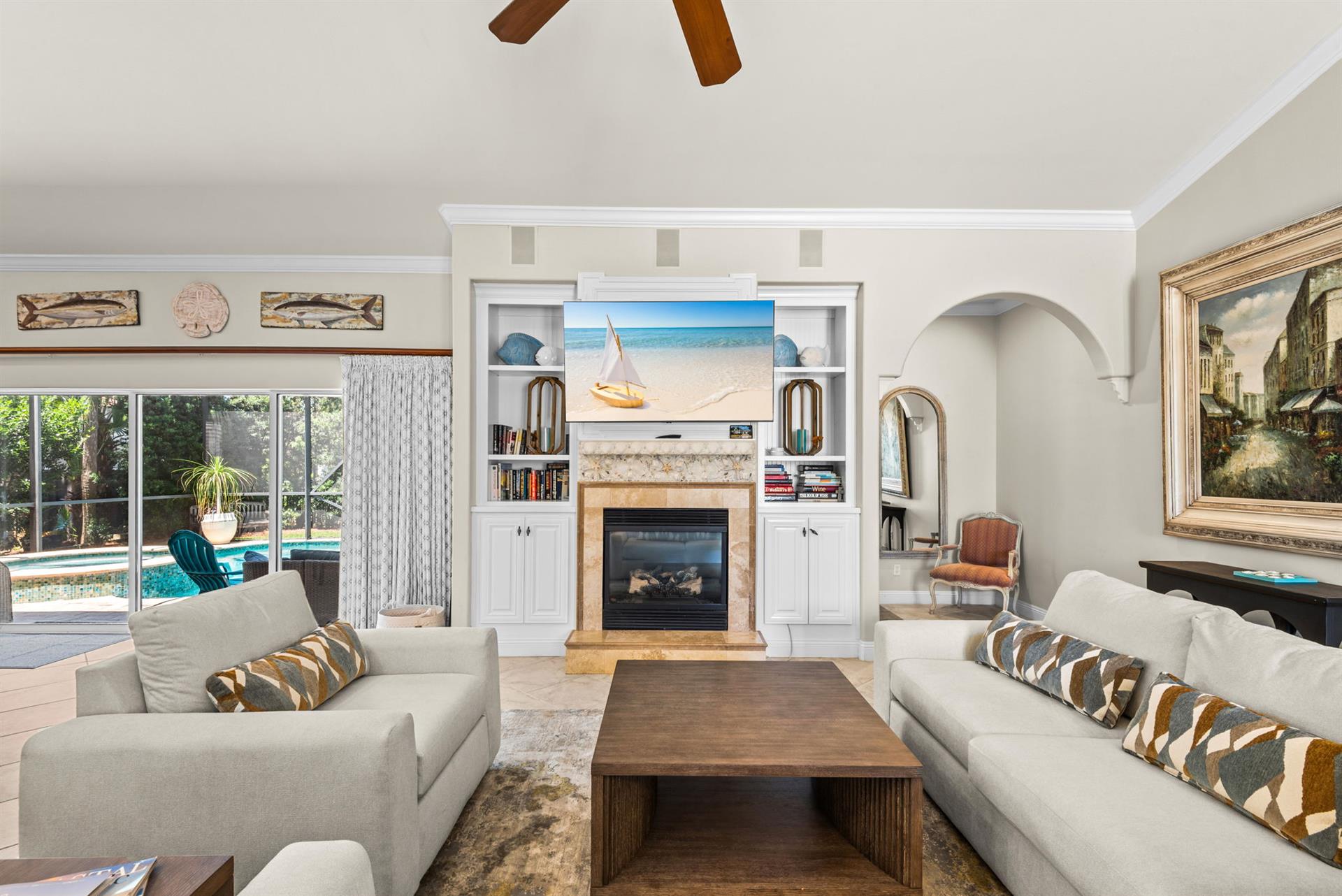 Settle into the bright living room, where beachy artwork and a cozy fireplace set the scene