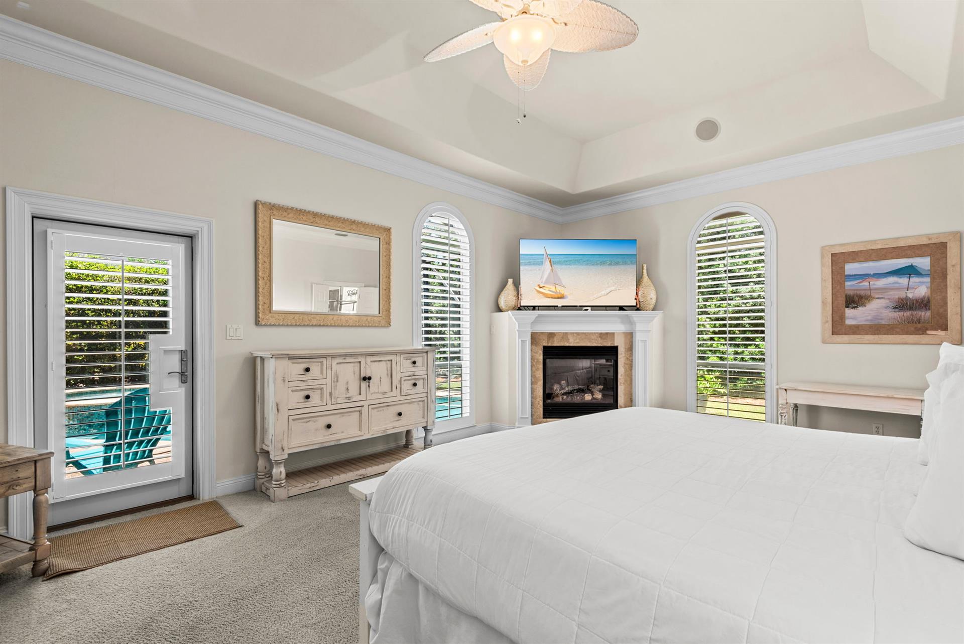 Unwind in this coastal bedroom, where direct patio access invites you to morning sunshine and peaceful poolside moments.