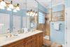 The 2nd floor bathroom features soothing aqua tones and a spacious walk in shower and double vanities.
