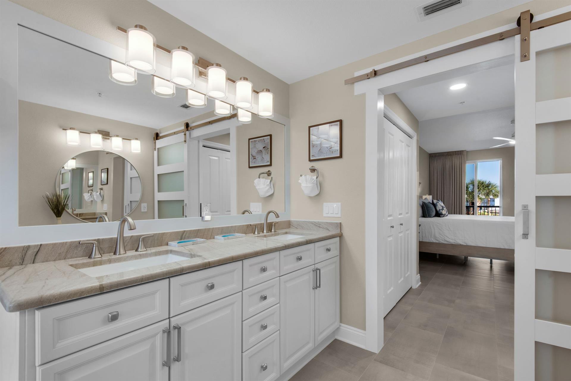 Step into the bright, spalike bathroom with dual sinks and sleek cabinetry
