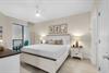 The guest bedroom with patio and large flat screen TV
