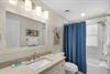The guest bathroom features a spalike tub and shower combo