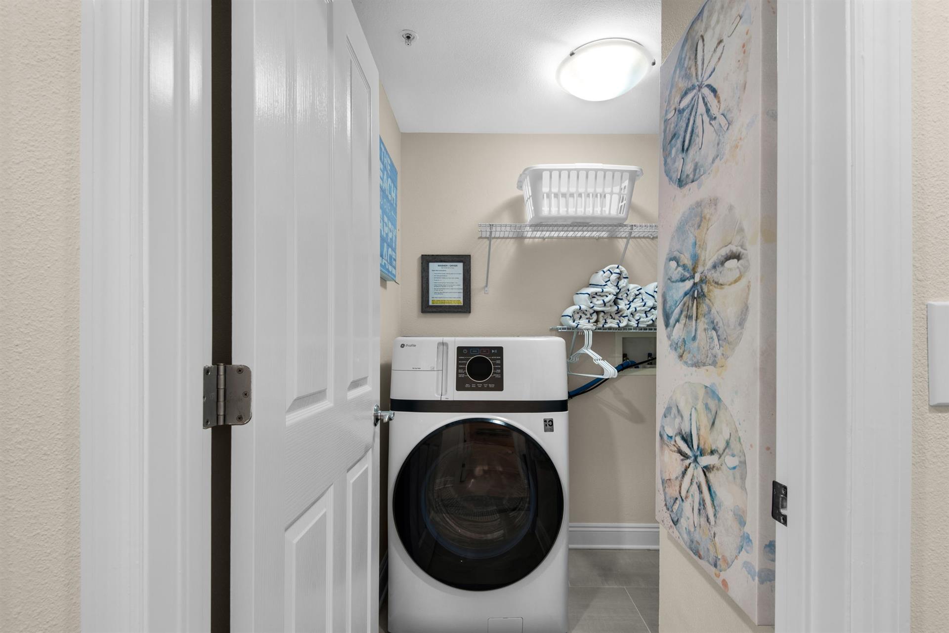 A dedicated laundry room features a fullsize washer and dryer