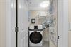 A dedicated laundry room features a fullsize washer and dryer