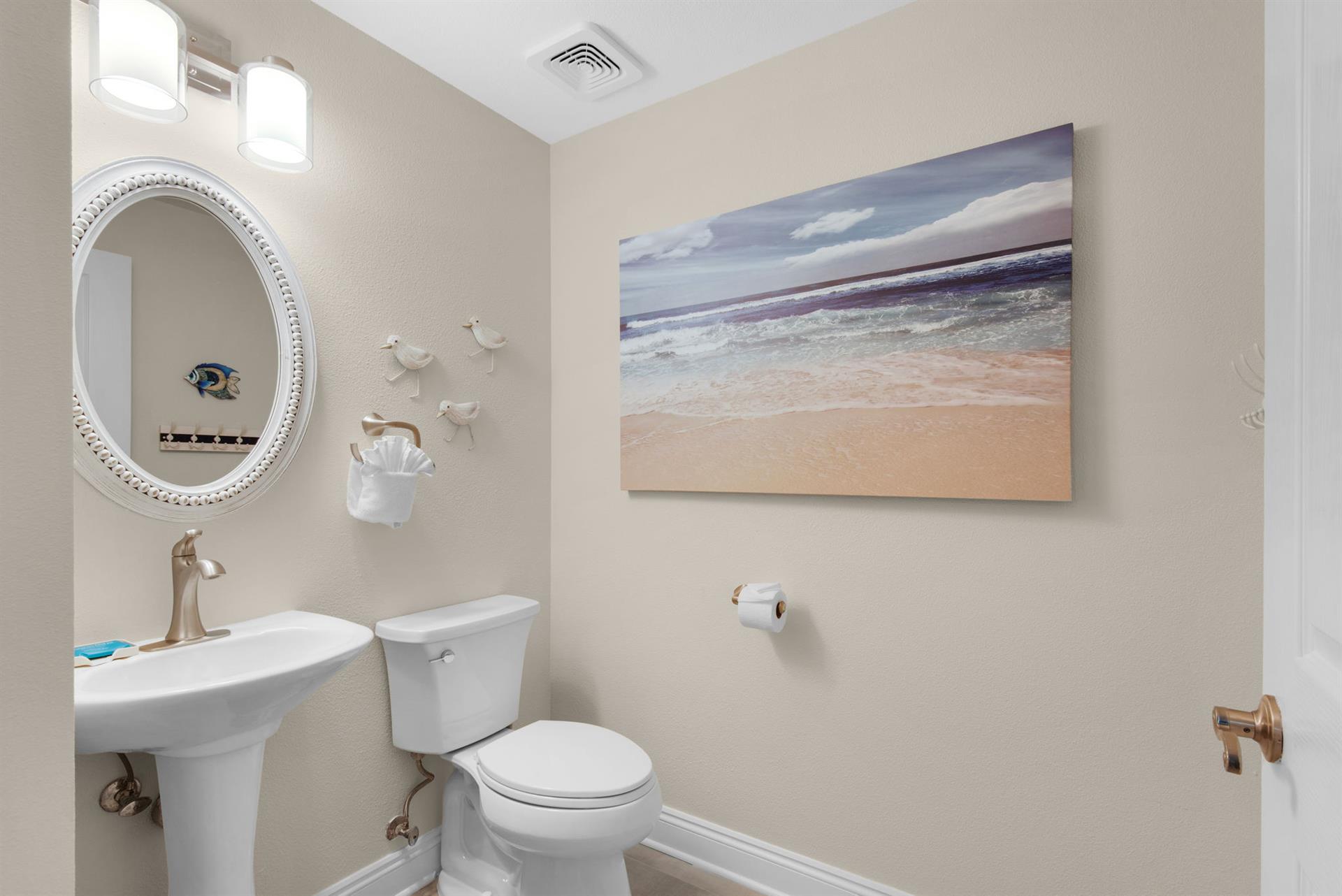 The convenient powder room with a pedestal sink