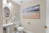 The convenient powder room with a pedestal sink