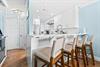 The modern kitchen features a breakfast bar perfect for morning coffee or casual meals.