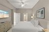 Drift off to sleep in this serene bedroom with coastal touches. Plush bedding, coastal artwork, and a ceiling fan create your perfect retreat after a day of adventure.