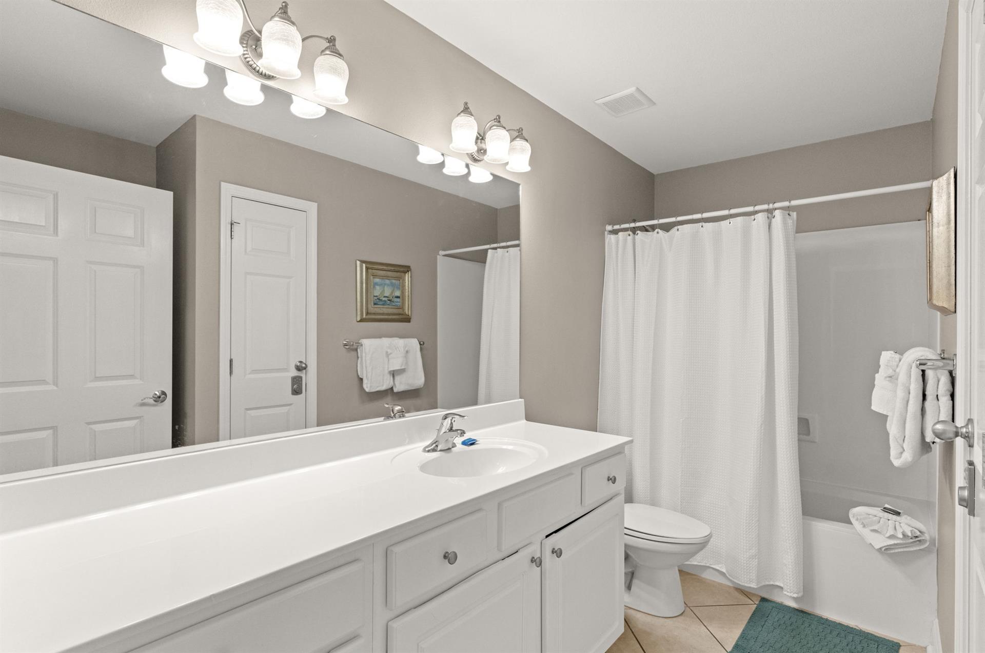 Freshen up in your guest bathroom, complete with and a soothing neutral palette that invites relaxation after a day of adventure.