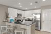 Kitchen with stainless steel appliances, granite countertops, and a convenient breakfast bar where you can gather for morning coffee and family meals.