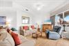 Unwind in your spacious living room with plush seating, coastal décor, and a ceiling fan to keep you cool.