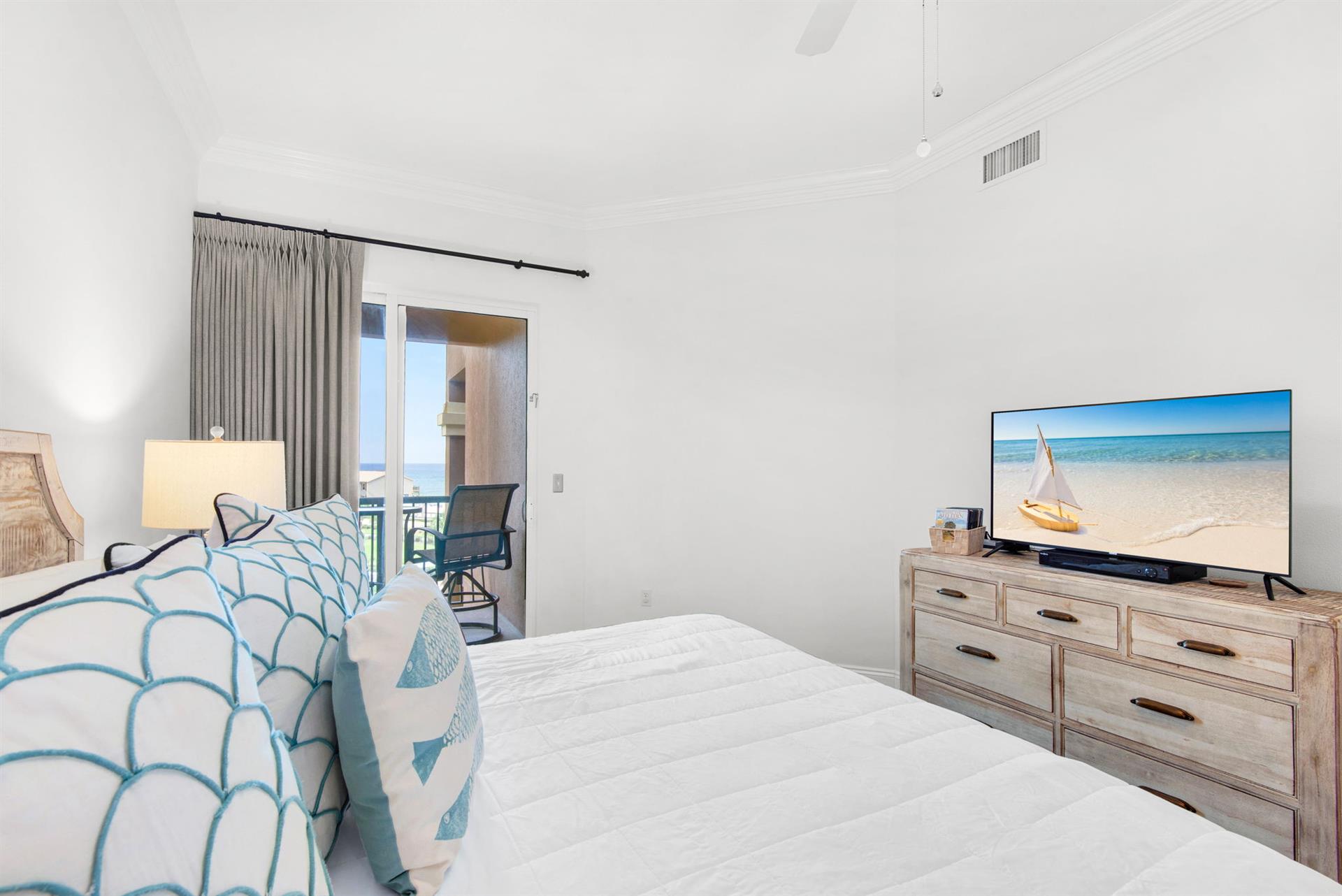 Sink into the Primary bedroom where soothing beach tones invite total relaxation.