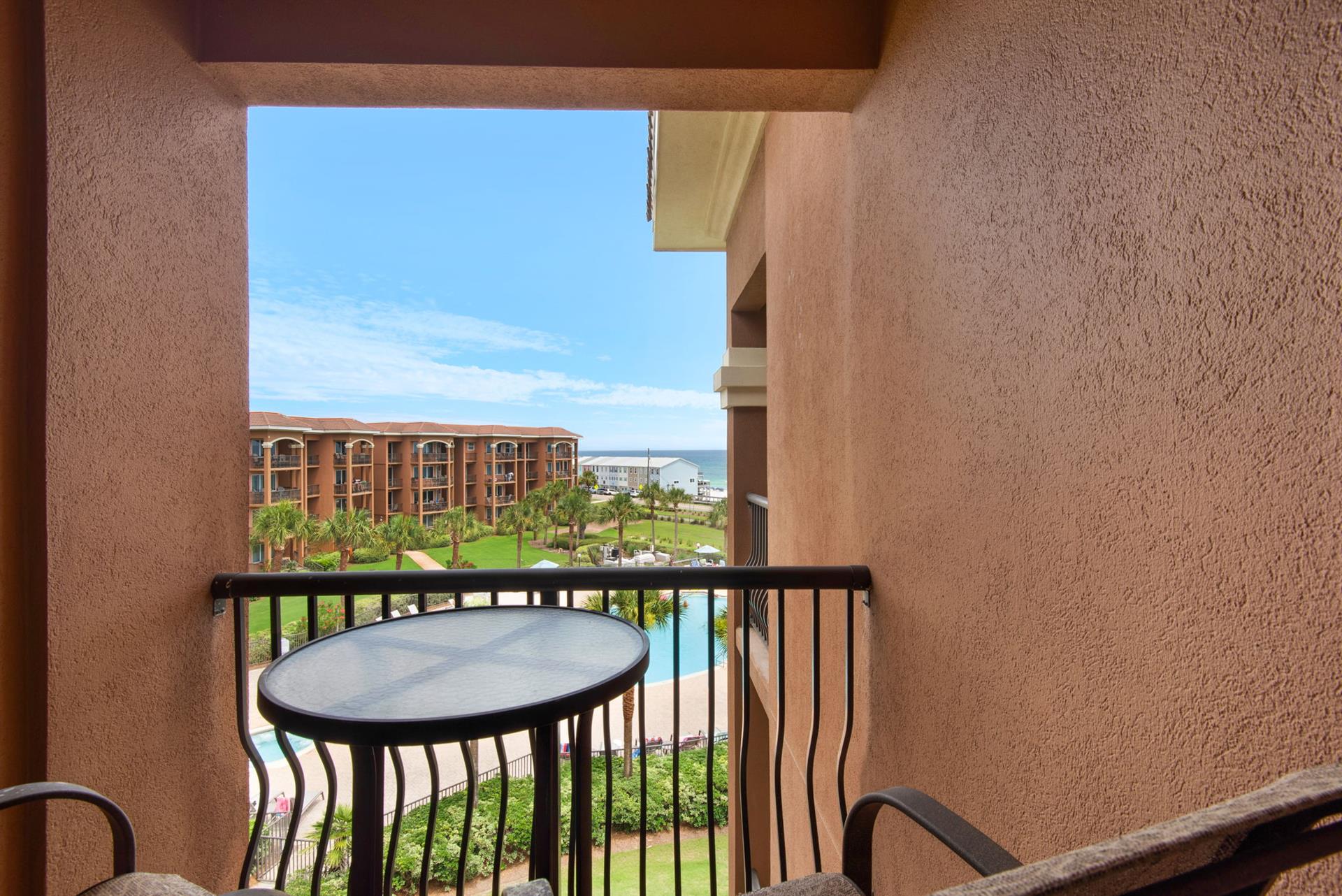 Step onto the balcony and take in the sweeping view of lush lawns and sparkling pool.