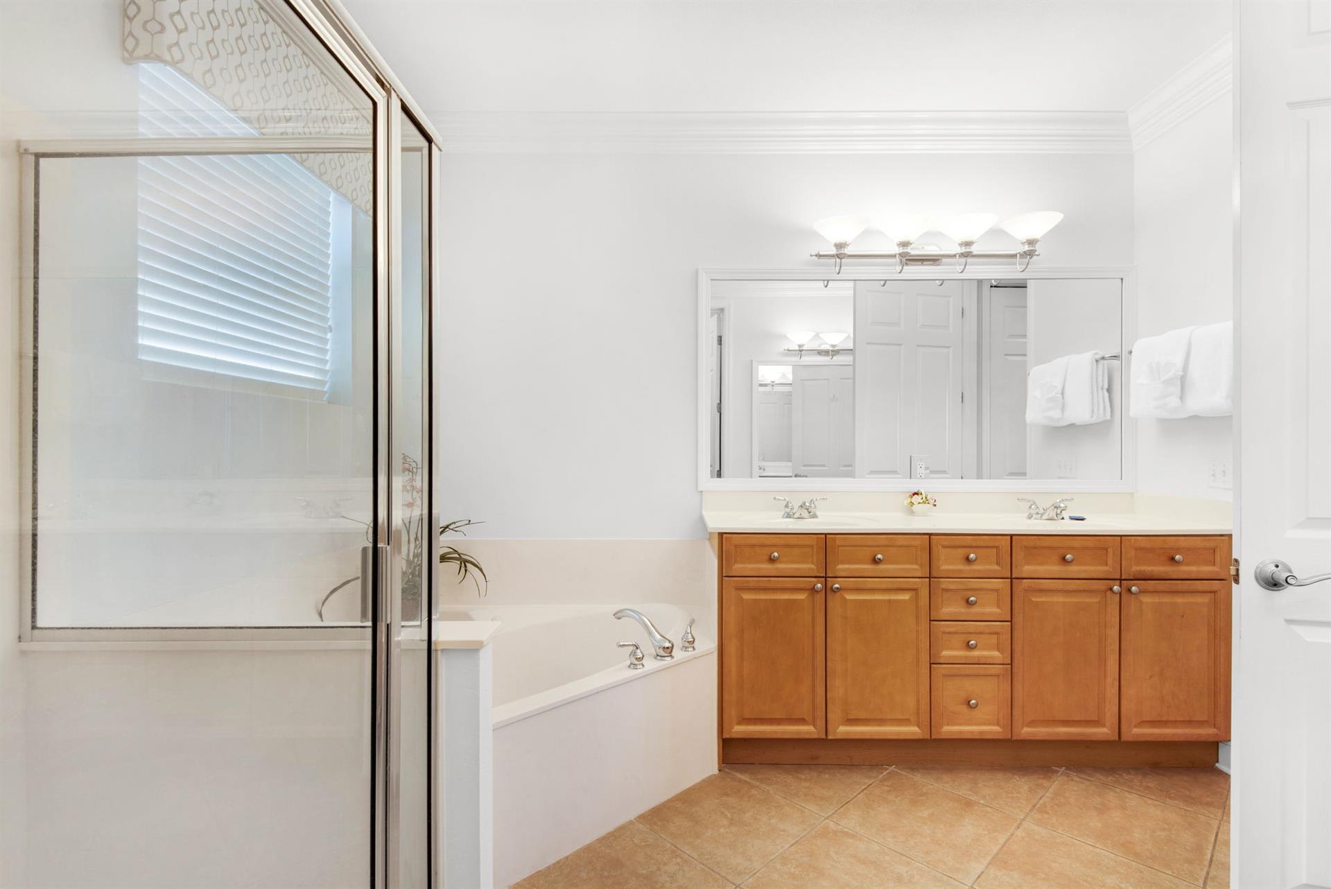 Refresh in your private spalike bathroom with a soaking tub, walkin shower, dual vanities, and warm wood finishes throughout.